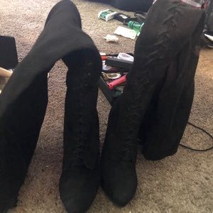 Knee high heeled laced boots